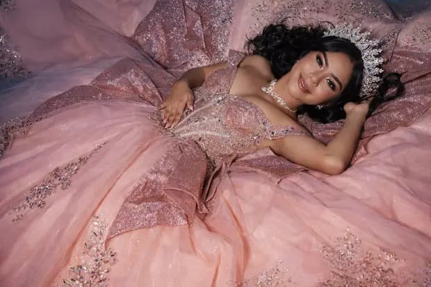 Wide quinceanera event photograph with warm styling.