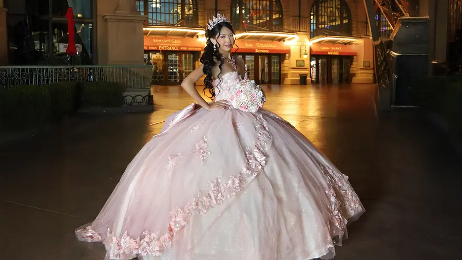 Quinceanera portrait in a pink gown at a Las Vegas landmark.